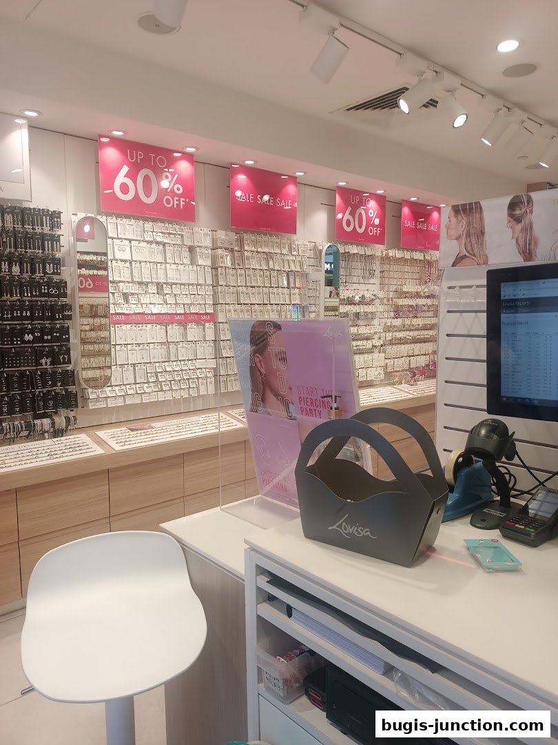 Interior of a Lovisa jewelry store with sale signs and displays of earrings.