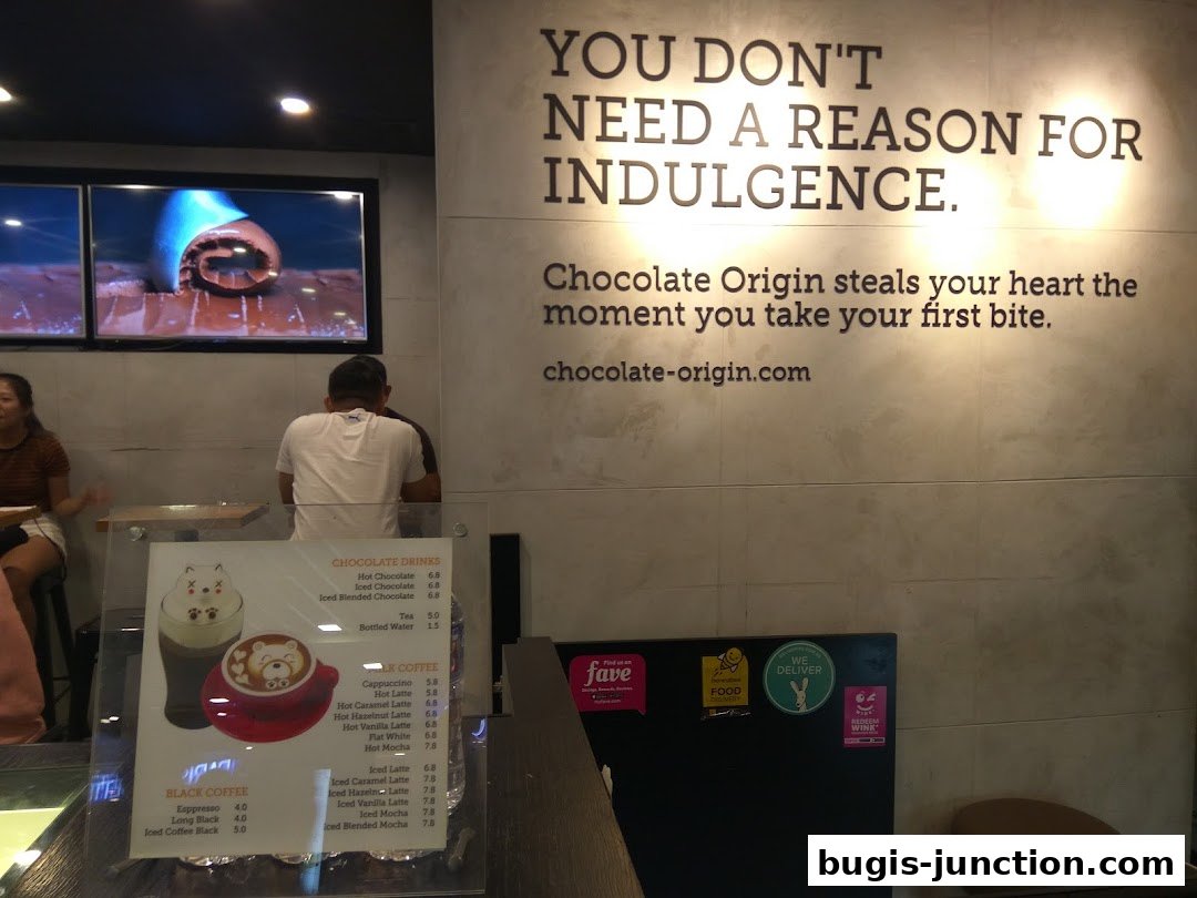 Interior of Chocolate Origin shop with a menu and motivational text on the wall.