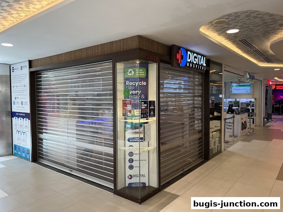 The exterior of a closed 'Digital Hospital' shop with roller shutters down.