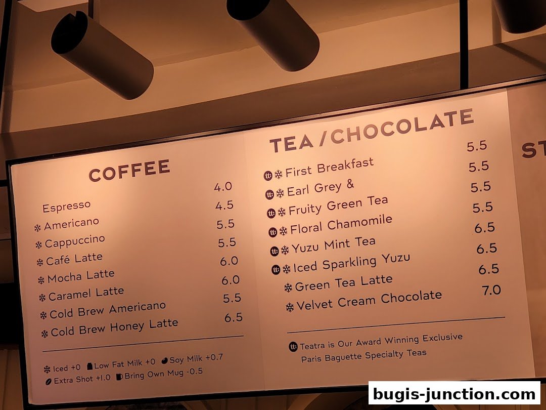 A menu board displaying coffee and tea/chocolate drinks with prices.