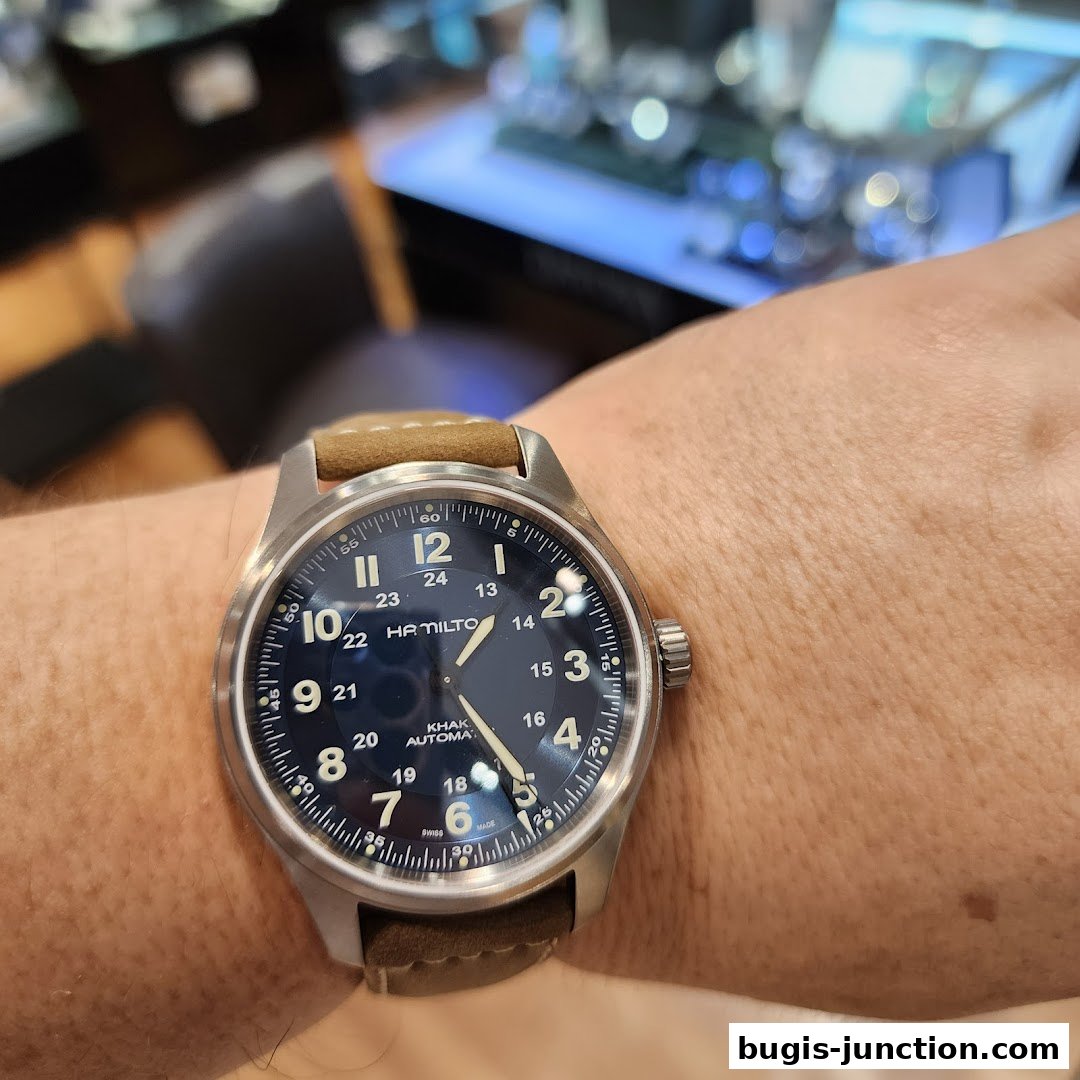 A close-up shot of a Hamilton Khaki Automatic watch on a person's wrist.