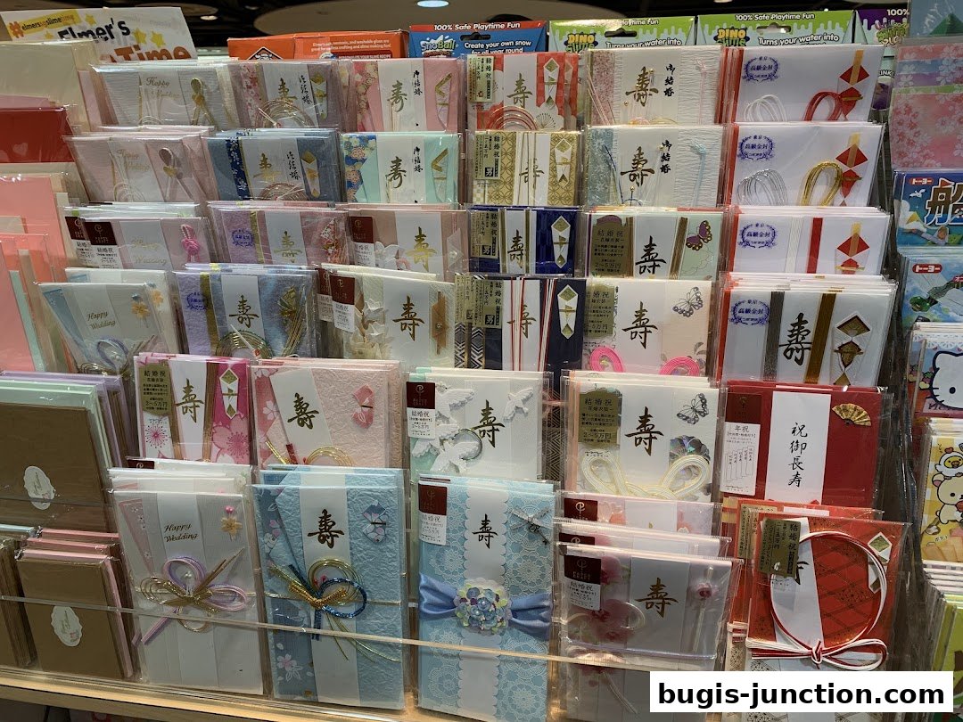 A display of various greeting cards and stationery items, many with Japanese characters and decorative elements.