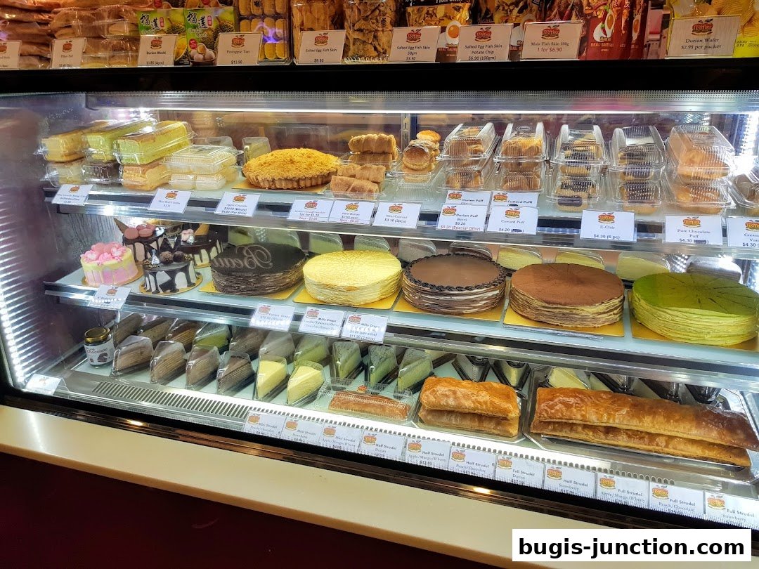 A display case filled with various cakes, pastries, and strudels, showcasing a wide selection of desserts.