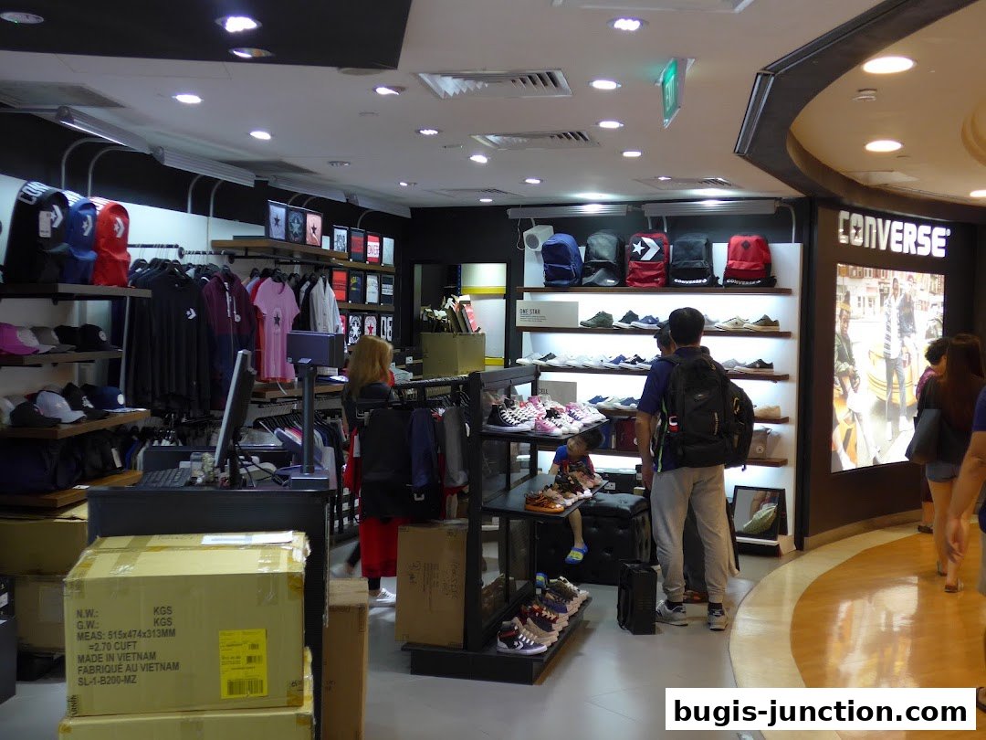 Interior view of a Converse store showcasing shoes, apparel, and backpacks.