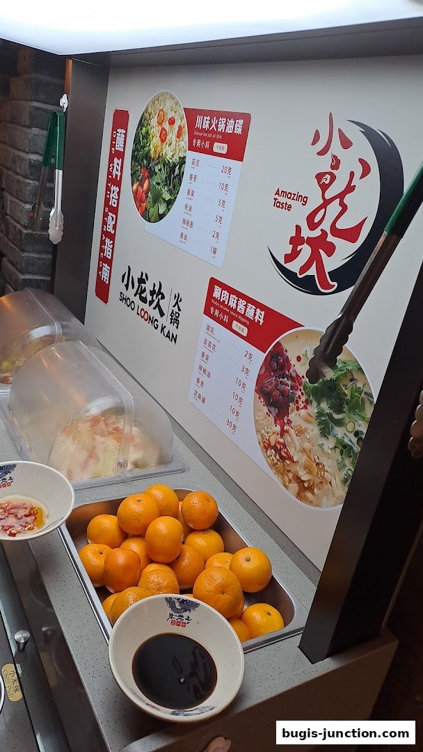 A display of hotpot ingredients and dipping sauces at Xiao Long Kan Hotpot.