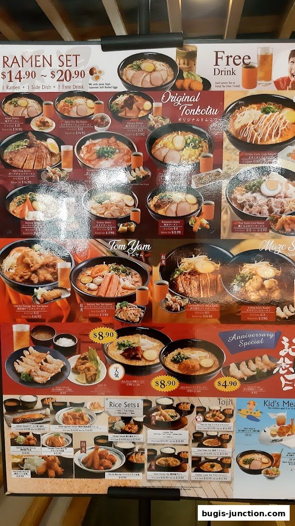 A menu board displaying various ramen sets, rice sets, and other Japanese dishes with prices.