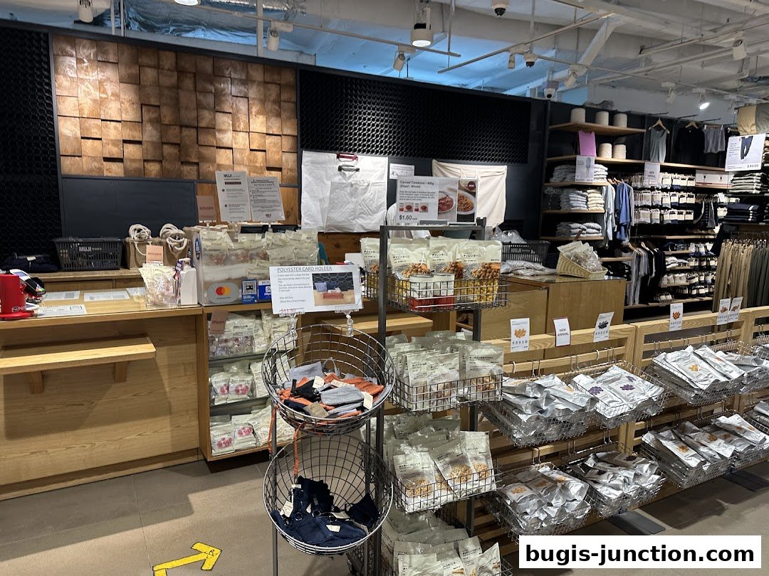 Interior view of a MUJI store showcasing clothing, snacks, and accessories.
