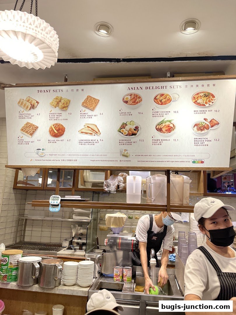 A menu board displaying various toast and Asian delight sets with images and prices.