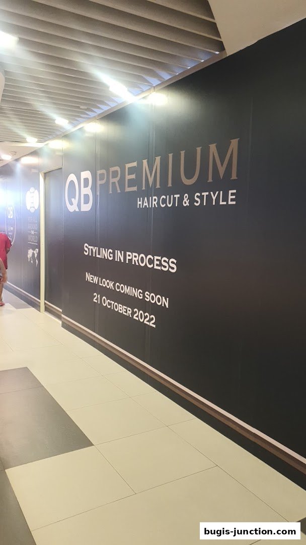 A shop front with 'QB PREMIUM HAIR CUT & STYLE' branding, announcing a new look coming soon.