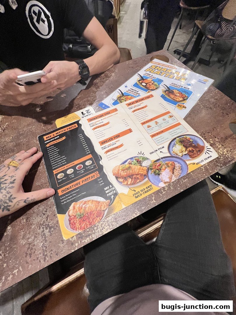A menu from Big Fish Small Fish Bugis Junction showing pasta and fish dishes.