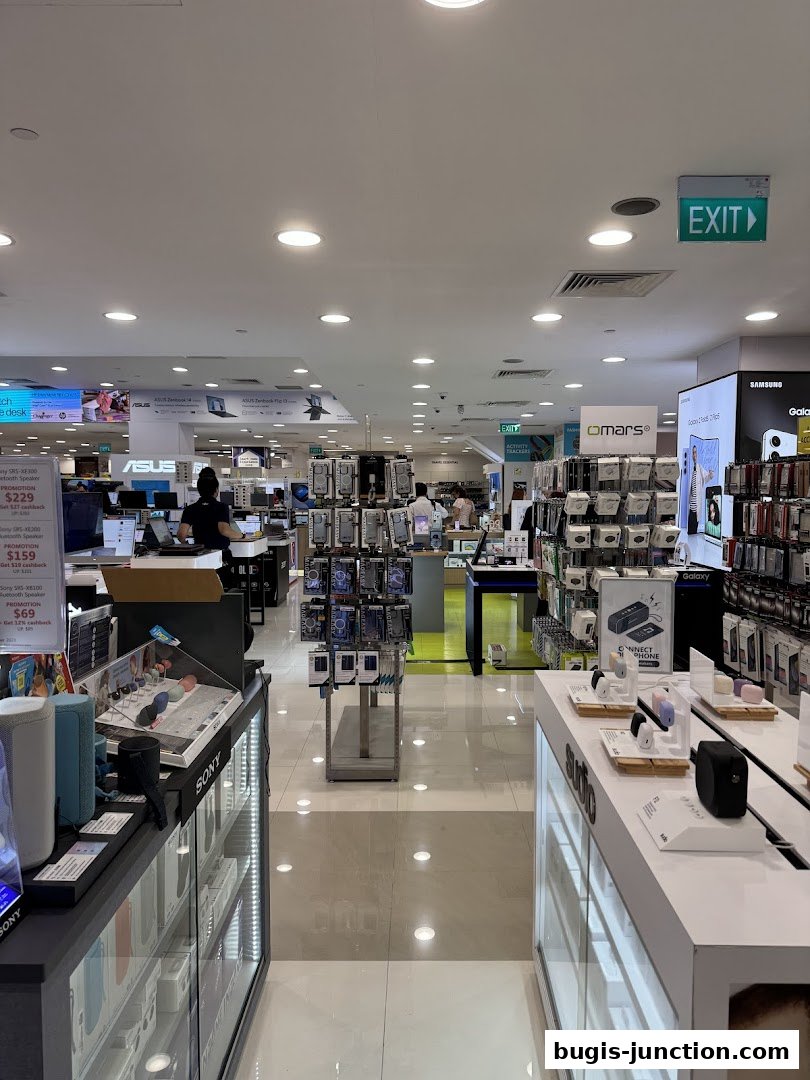 Interior view of a well-lit electronics store showcasing various gadgets and displays.