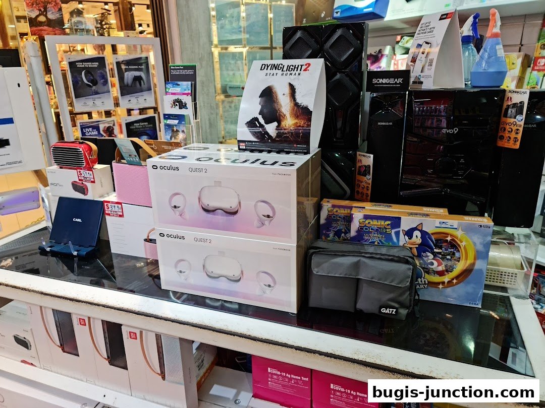 A display of gaming consoles, VR headsets, and accessories, including Oculus Quest 2 and Sonic Colors.