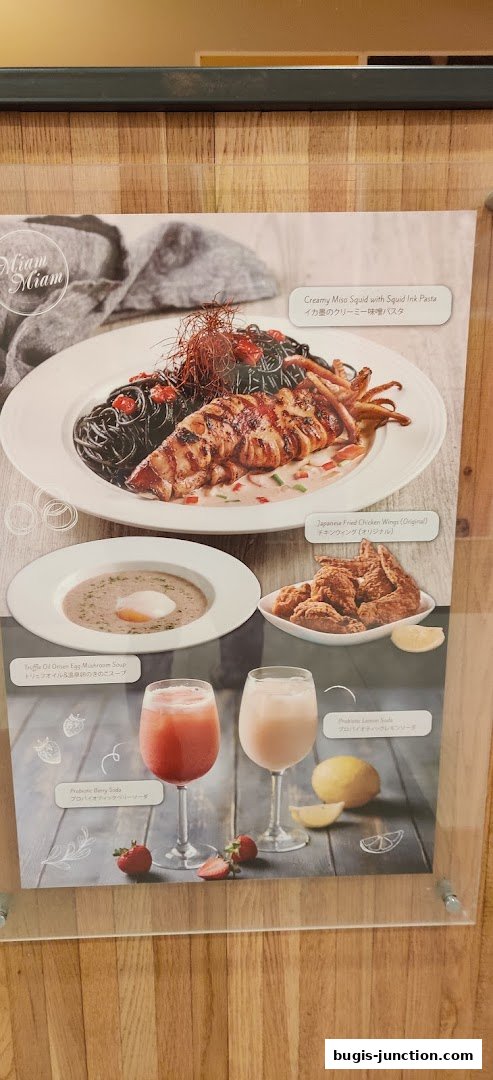 A menu display featuring Japanese-inspired dishes and drinks from Miam Miam.