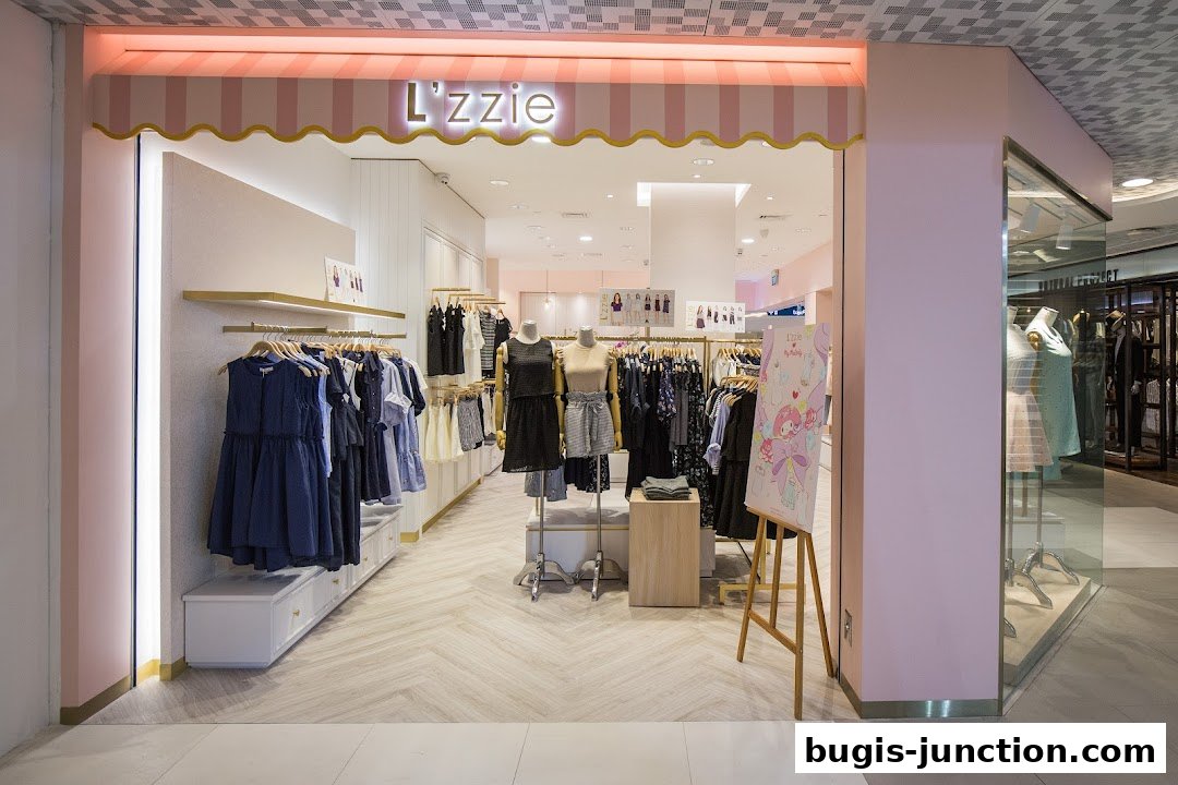 The entrance of a stylish clothing boutique named L'zzie, showcasing fashionable apparel on racks and mannequins.