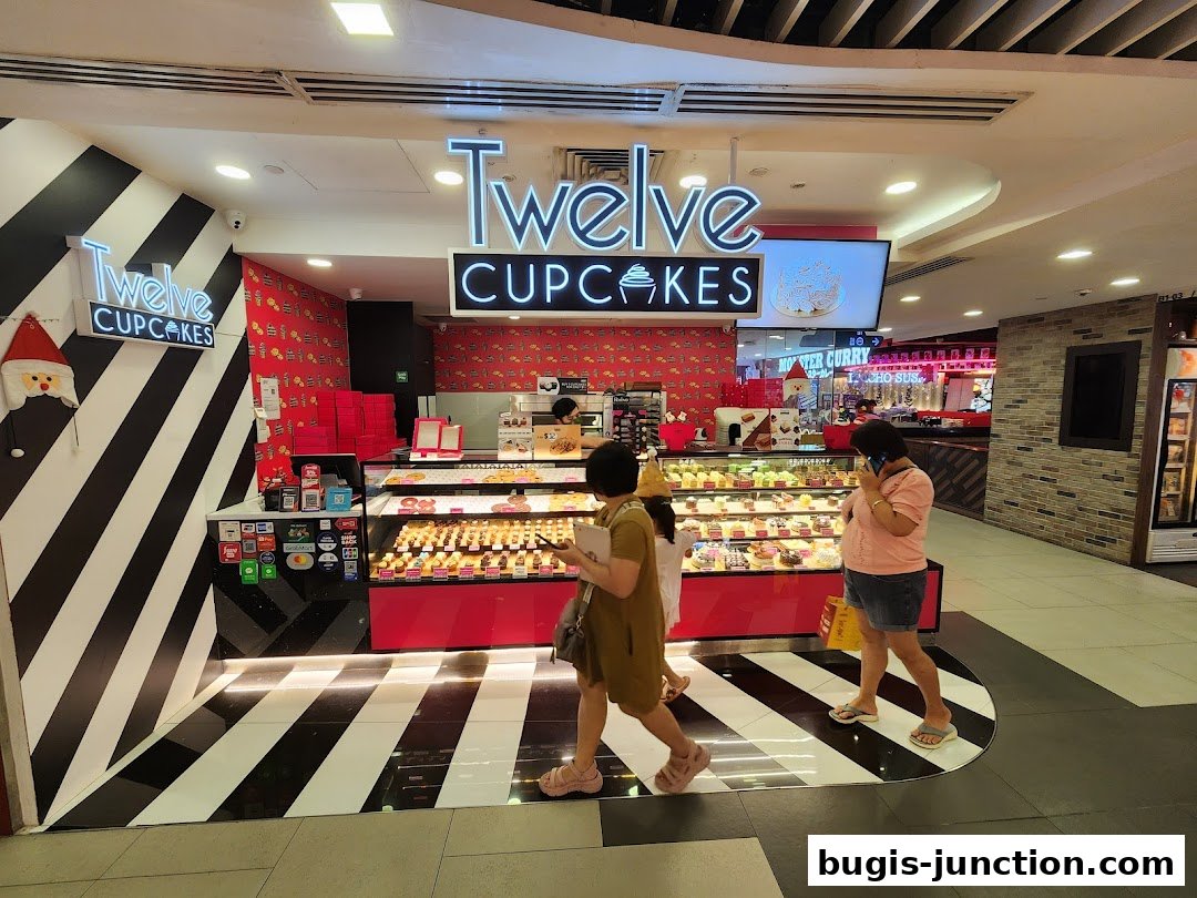 A bright and inviting cupcake shop with a display of colorful cupcakes and a festive Santa decoration.