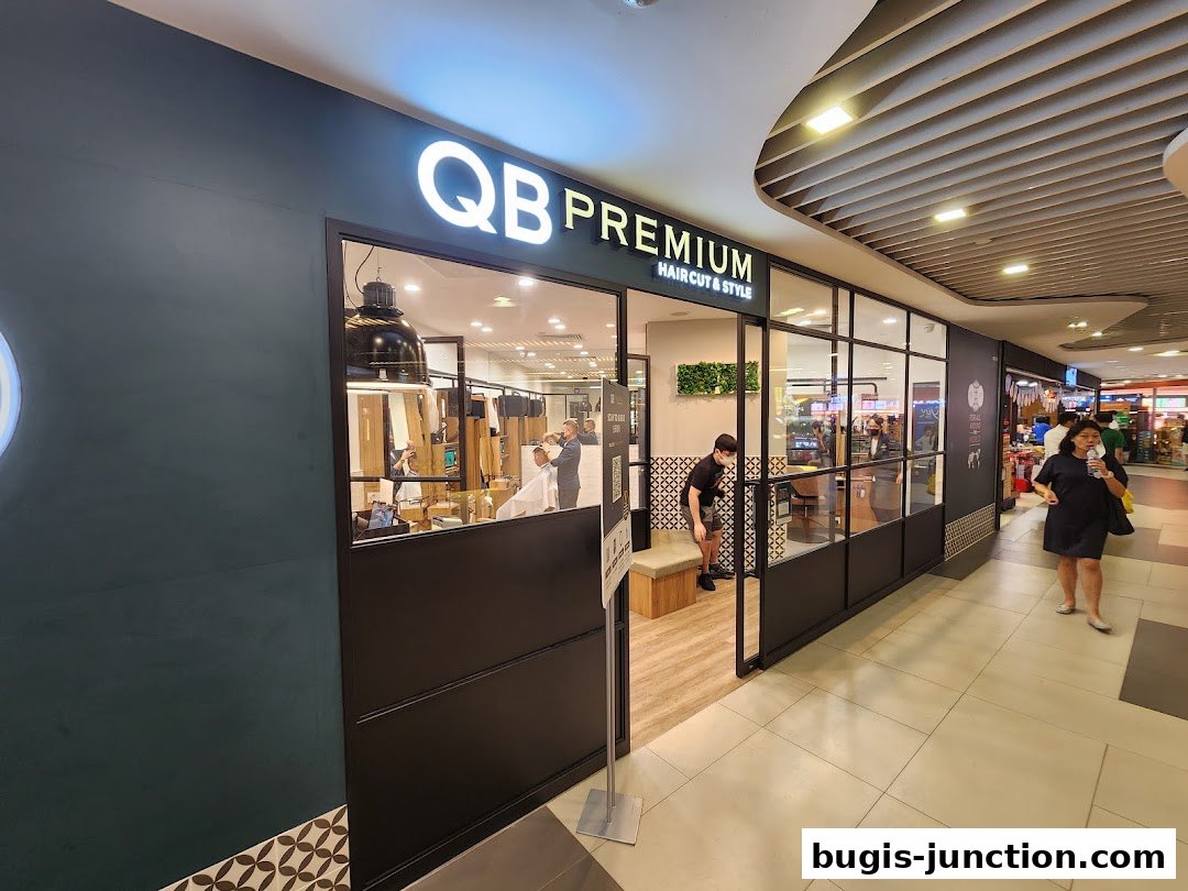 The exterior of QB PREMIUM hair salon with a person entering the shop.