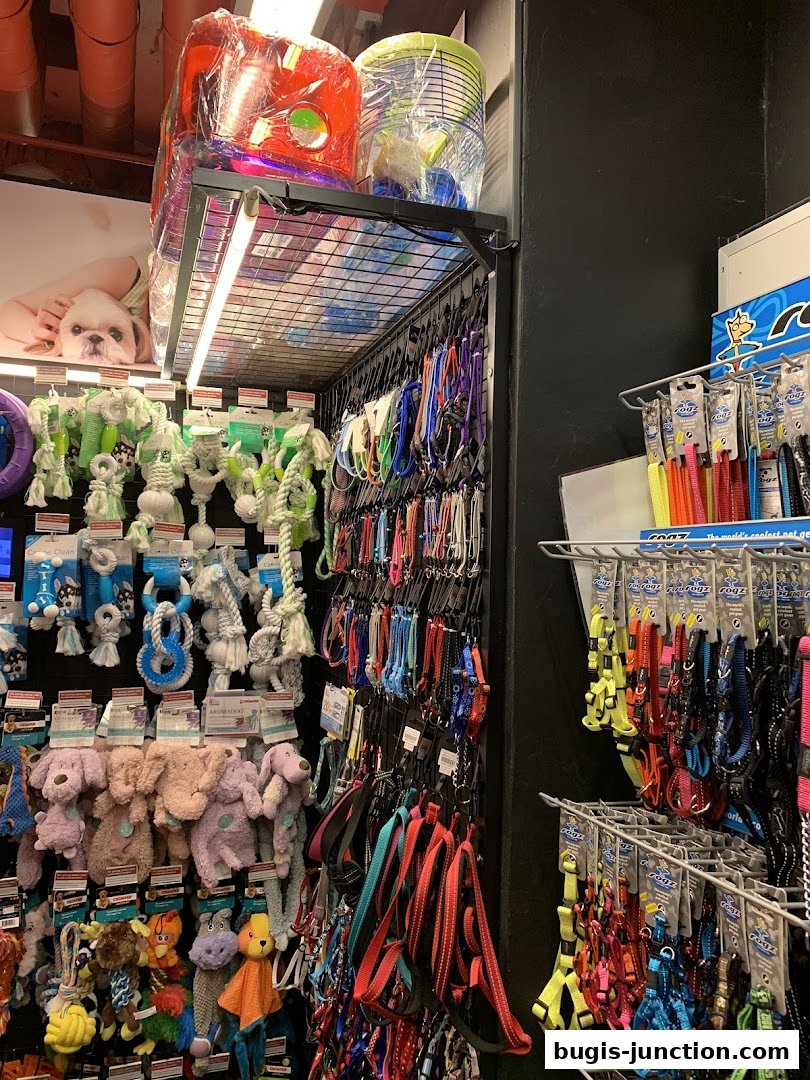 A wide selection of pet accessories, including leashes, collars, and plush toys, neatly displayed on shelves.