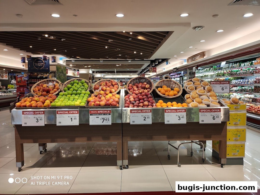 A display of fresh fruits with special offers at a grocery store.