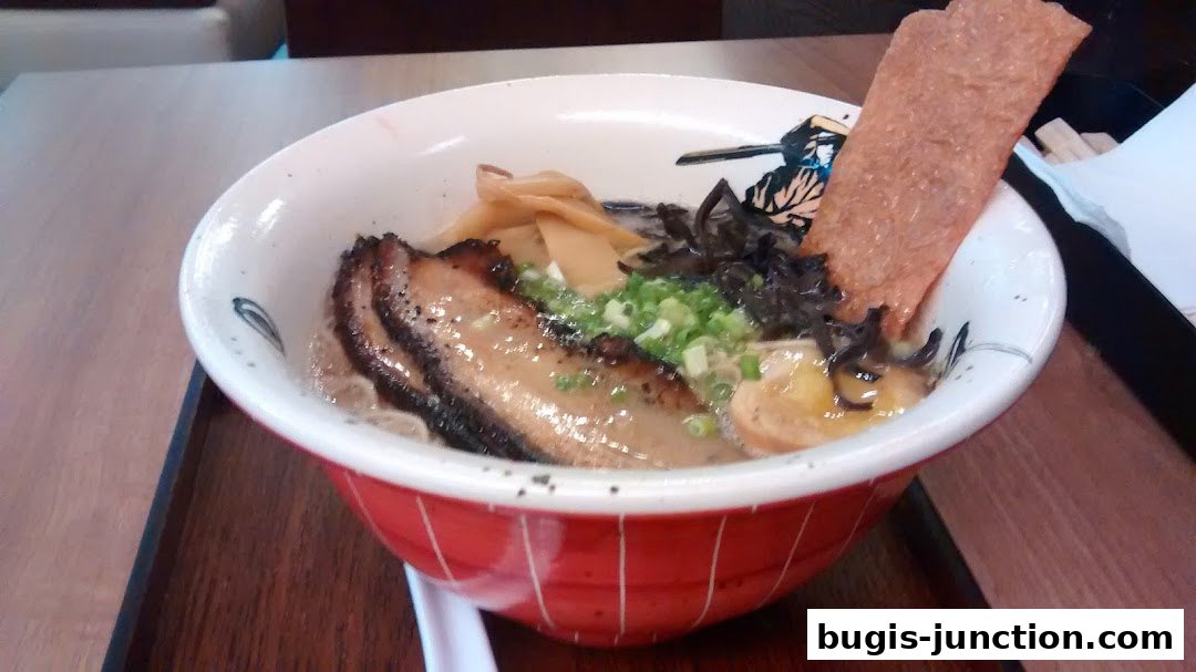A close-up shot of a delicious bowl of ramen with tender pork belly and toppings.