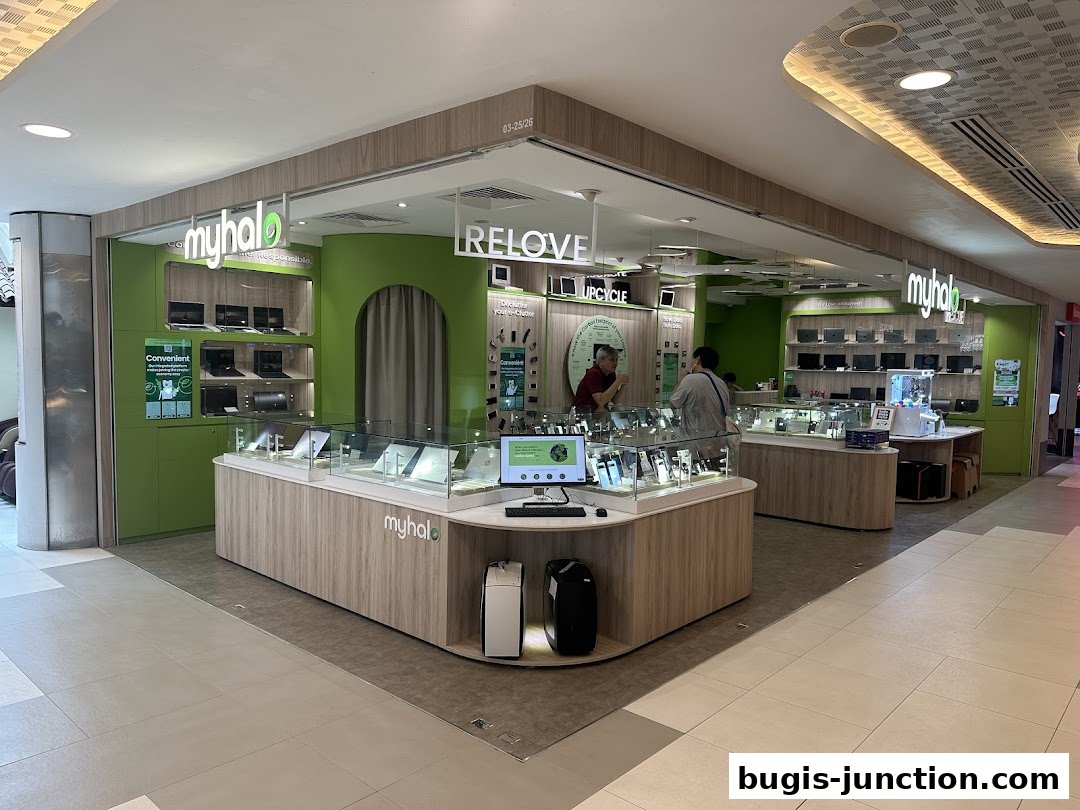 A brightly lit electronics store selling laptops and accessories, with a focus on circular economy.