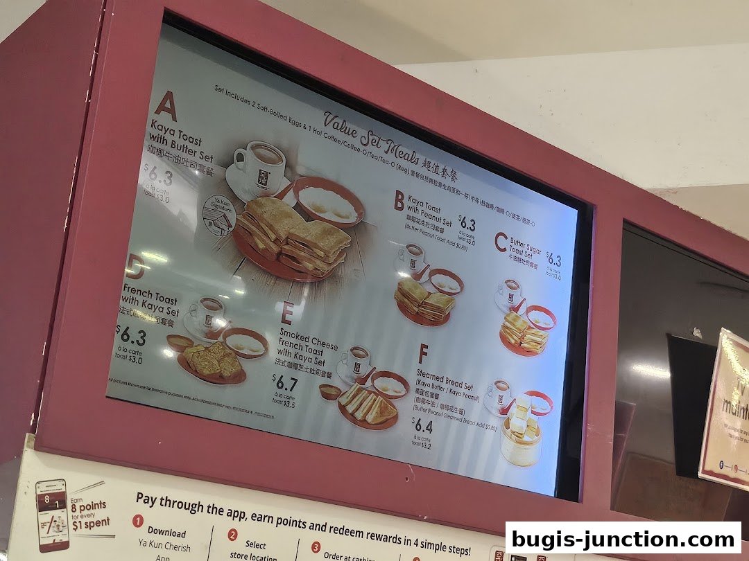 A digital menu board displaying various value set meals from Ya Kun Kaya Toast.