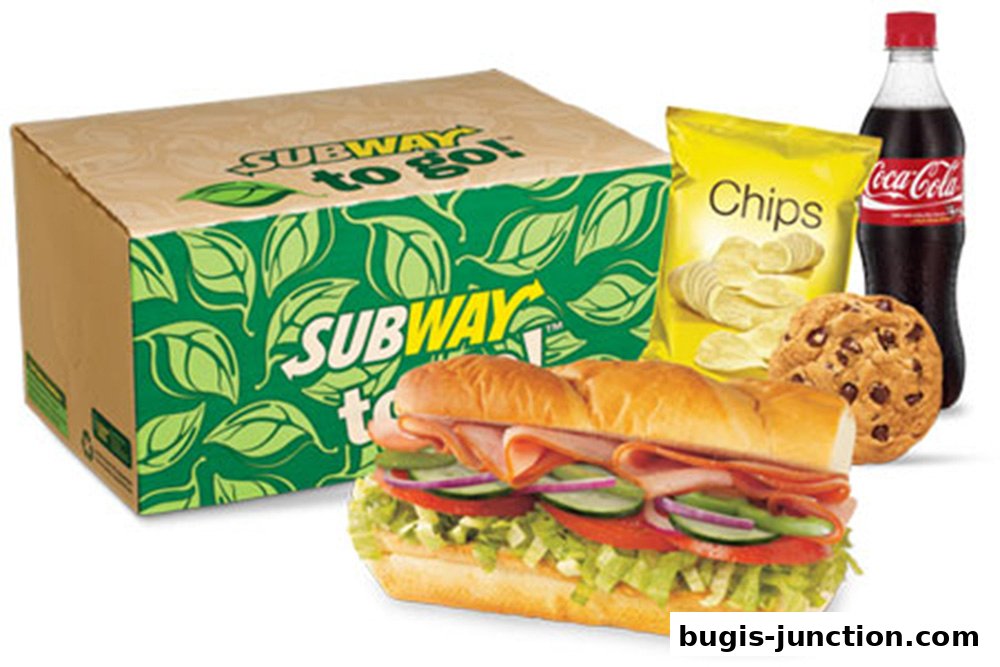 A Subway sandwich meal with a drink, chips, and a cookie.
