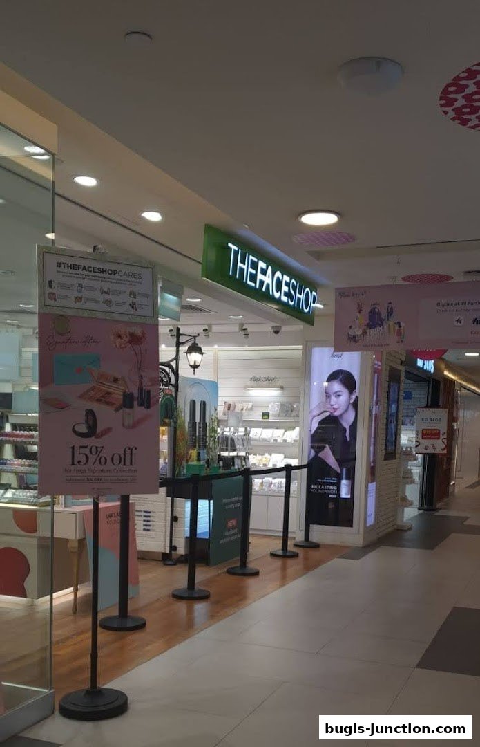 The exterior of THEFACESHOP store with promotional signage and product displays.