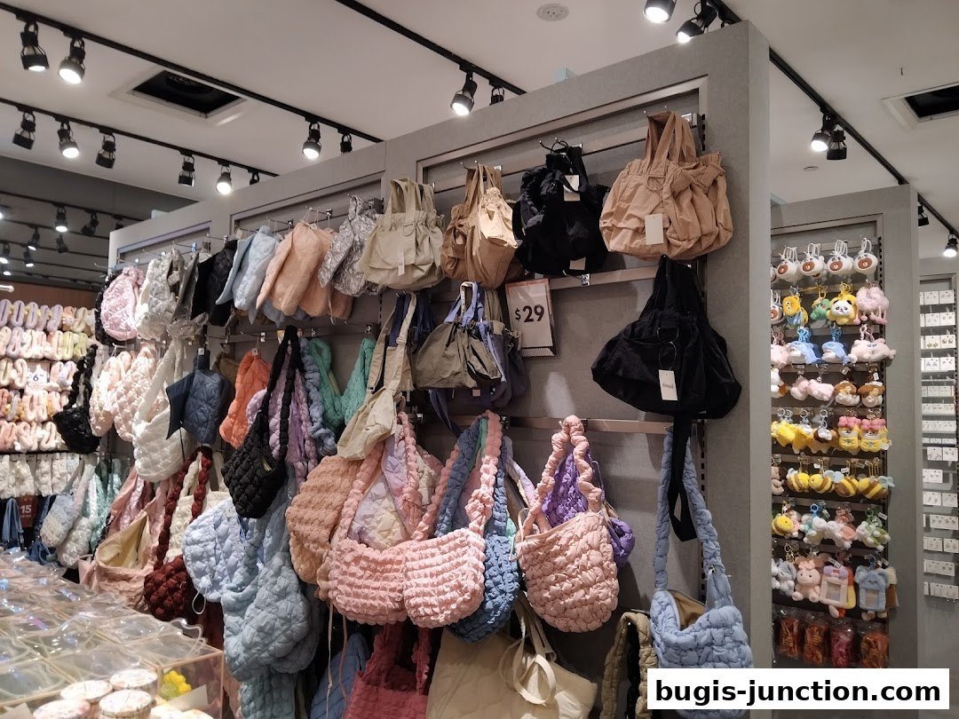 A retail shop interior displaying a variety of textured bags and plush keychains.