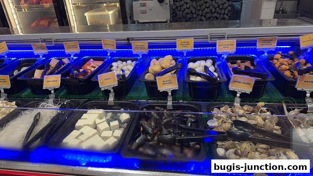 A display of various fresh ingredients for hot pot, including seafood, meats, and vegetables.
