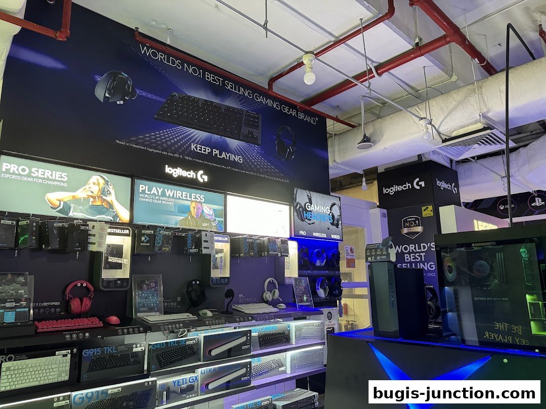 Interior view of a Challenger store showcasing Logitech gaming peripherals and computer hardware.