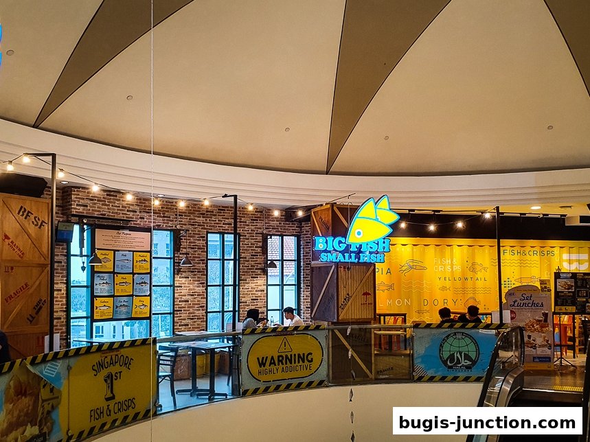 The interior of Big Fish Small Fish restaurant with a prominent sign and seating area.