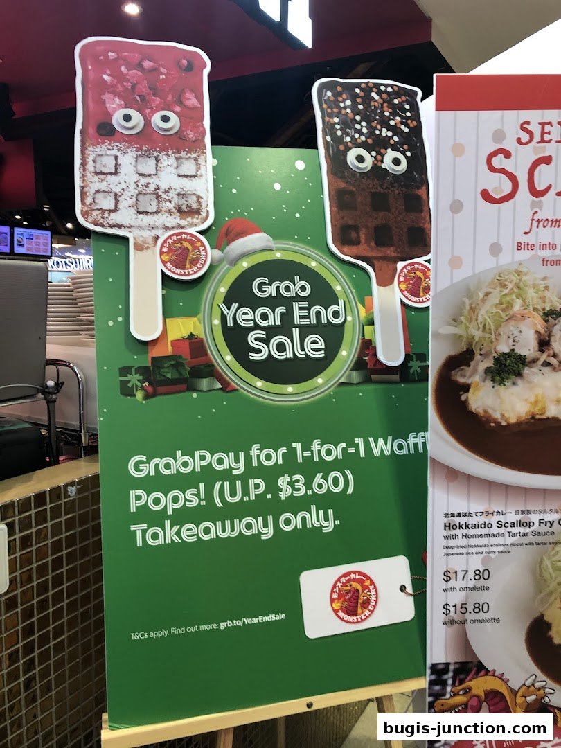 A festive promotion for Monster Curry's 1-for-1 Waffle Pops, featuring holiday decorations.