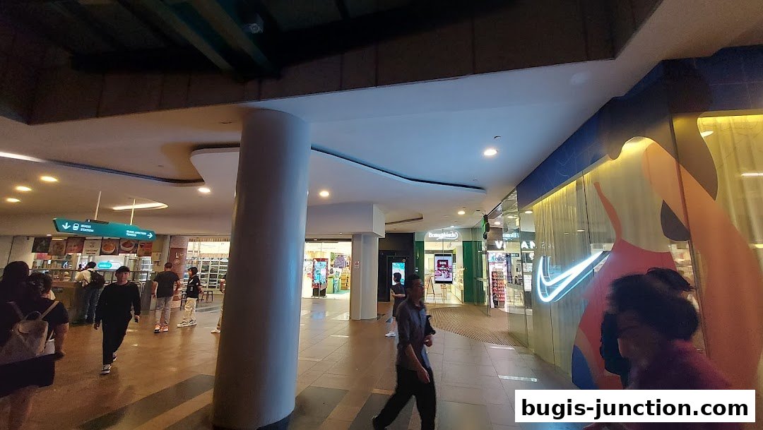 The exterior of a Nike store with its iconic logo and a large graphic on the window.