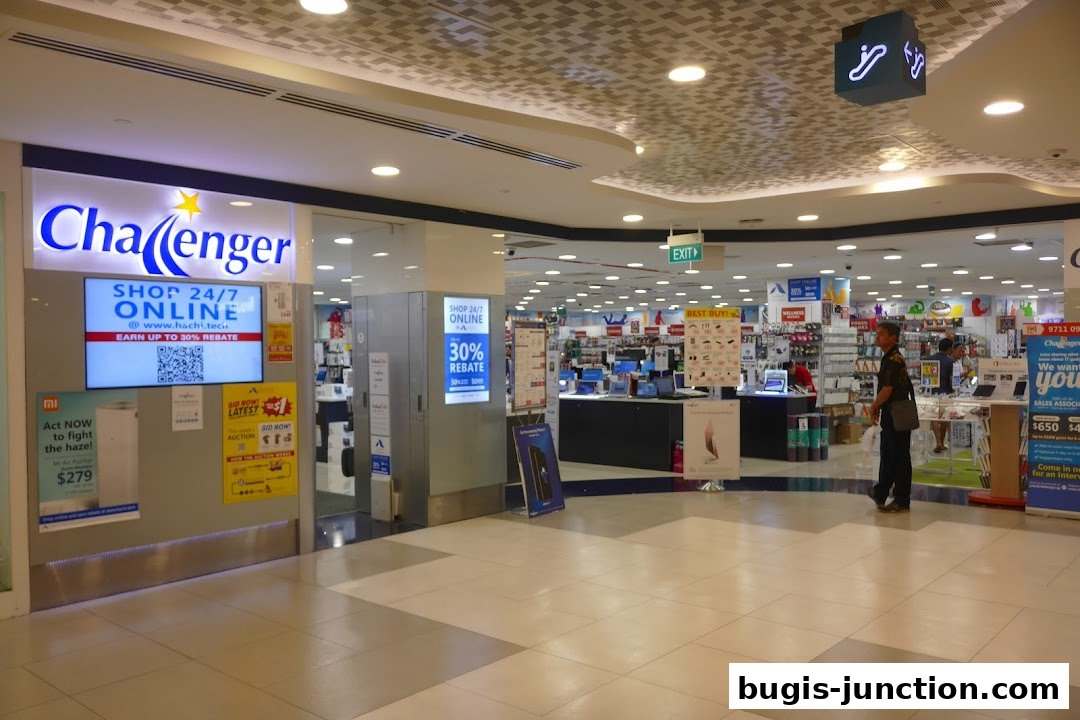 The Challenger Bugis Junction Flagship Store entrance with digital displays and product displays inside.