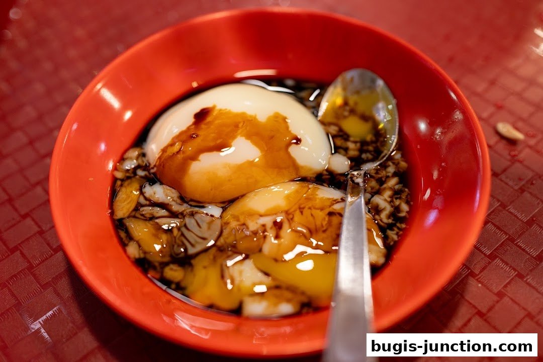 A close-up of soft-boiled eggs in a red bowl with soy sauce and pepper.