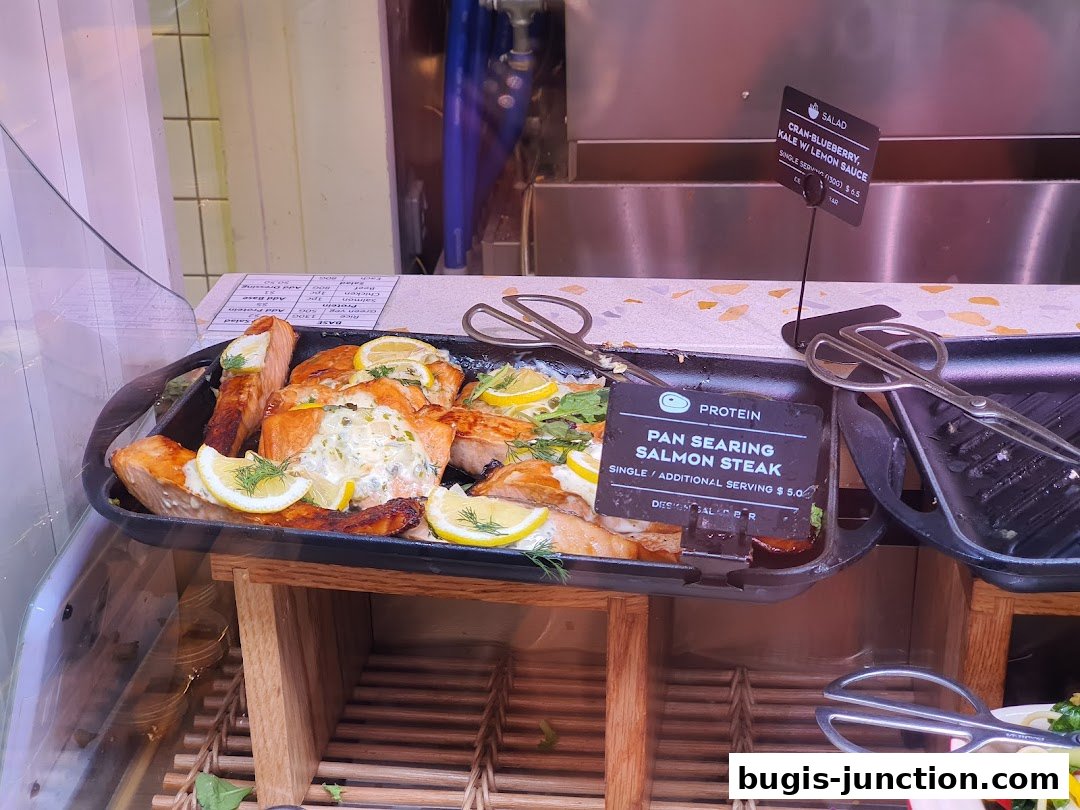 Pan-seared salmon steak with lemon and dill, served with a side salad.