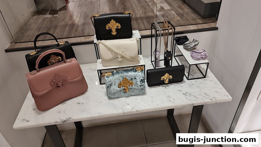 A display of elegant handbags in various colors and styles on a marble-topped table.