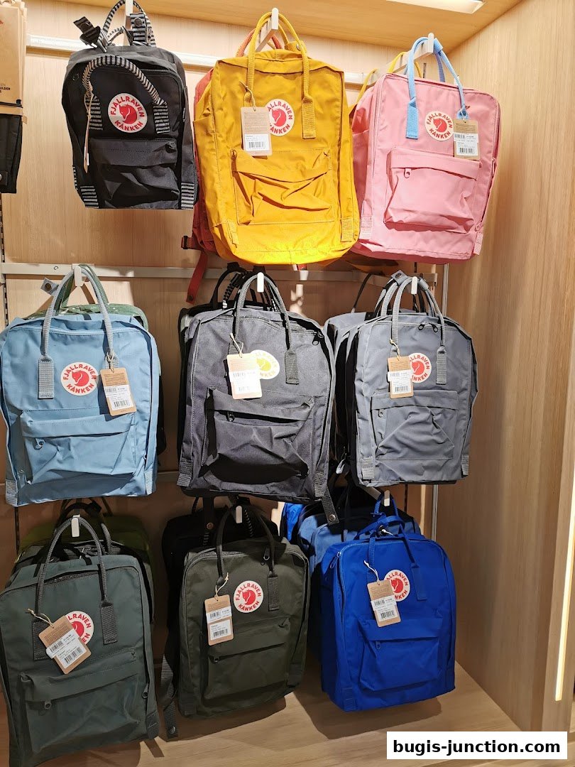 A display of colorful Fjallraven Kanken backpacks in various sizes and colors.
