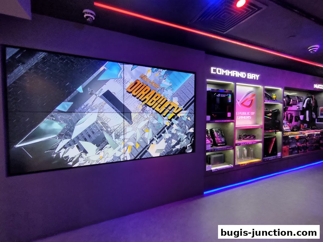 Interior of the ROG Experience Store showcasing gaming PCs, accessories, and a large display screen.