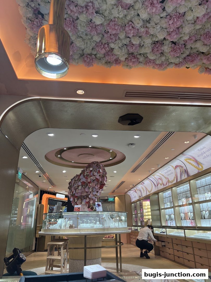 Interior view of a luxurious jewelry store with displays and a staff member.