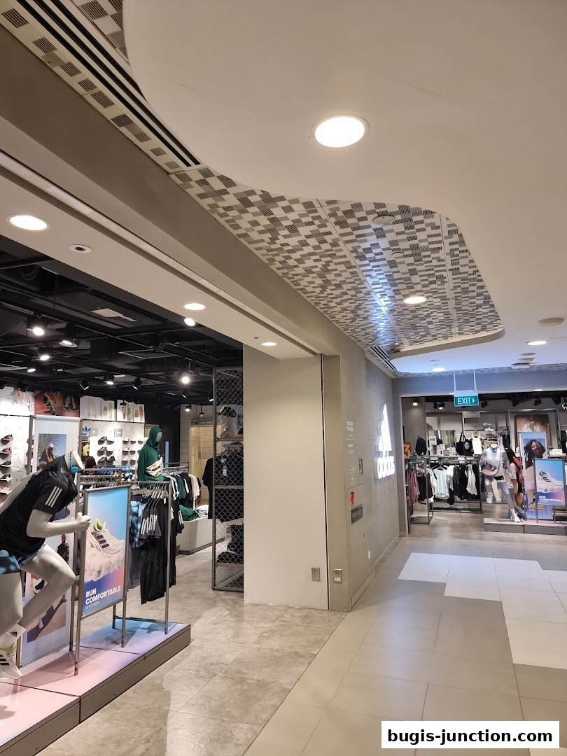 Interior view of an Adidas Performance Store showcasing athletic wear and mannequins.