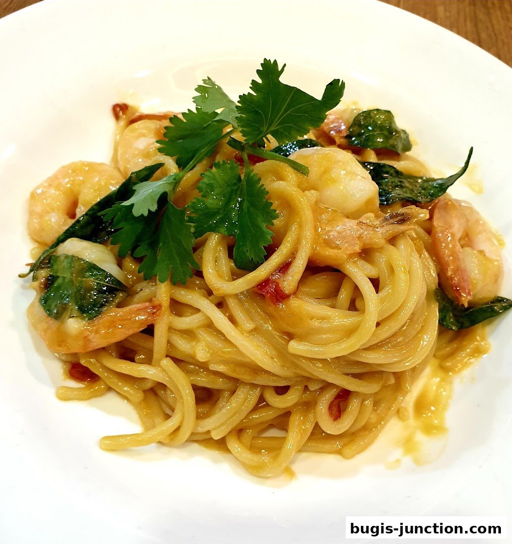 A close-up shot of a delicious pasta dish with shrimp and fresh herbs.