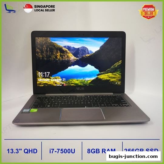 A laptop with a scenic wallpaper is displayed, highlighting its specifications.