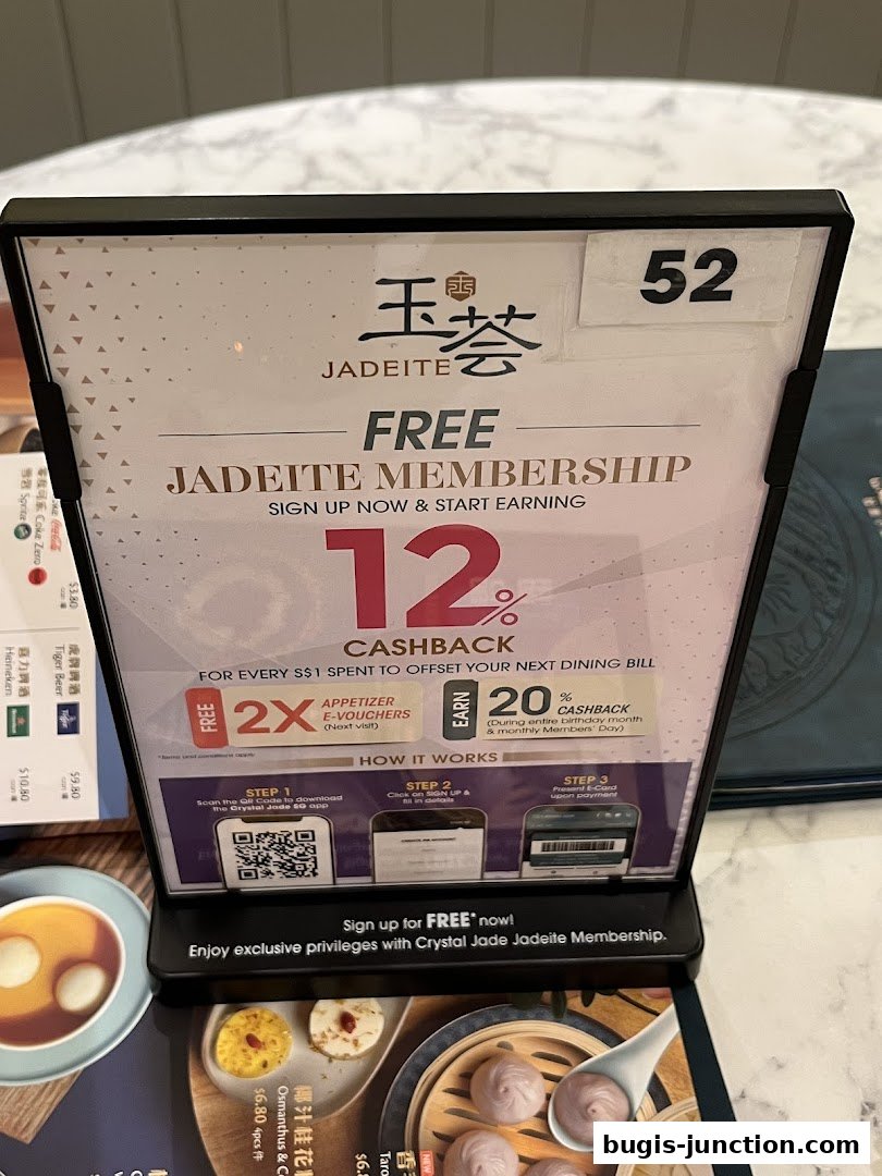 A sign promoting a free Jadeite membership with cashback and e-vouchers.