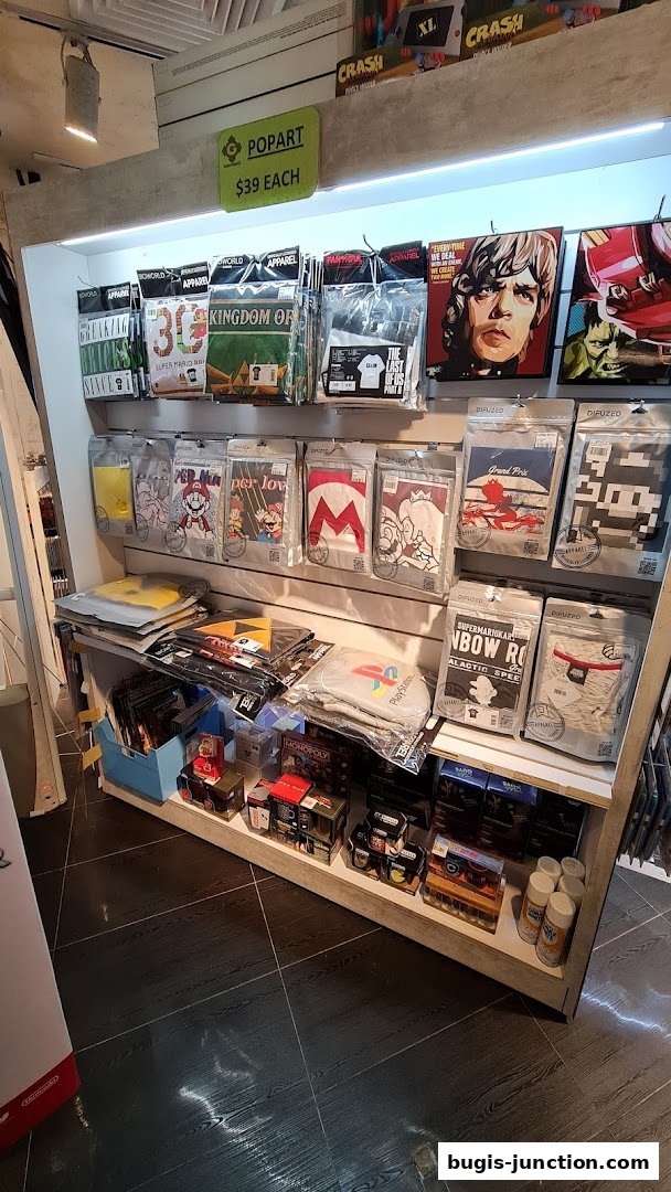 A retail display featuring pop art themed apparel and merchandise, including t-shirts and posters.