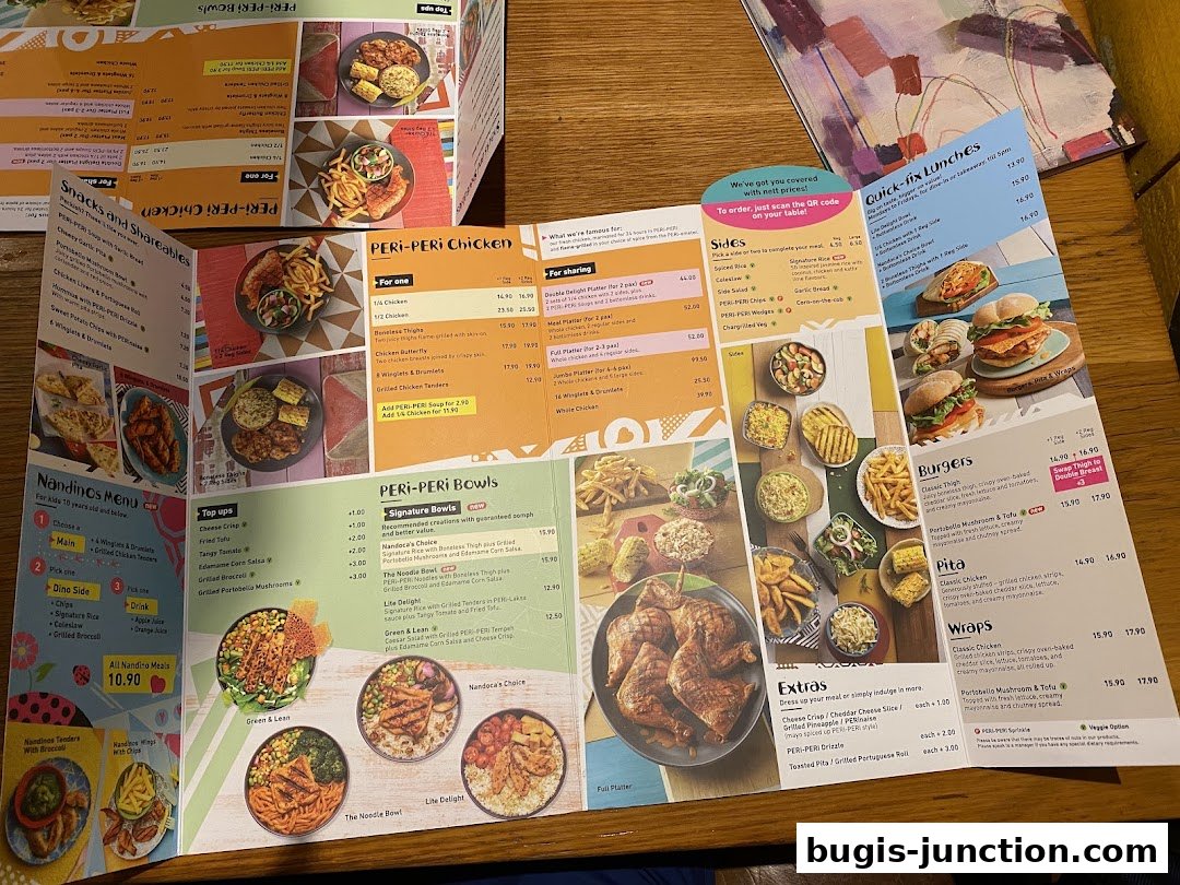 A spread of Nandos menus showcasing various chicken dishes, bowls, burgers, and sides.