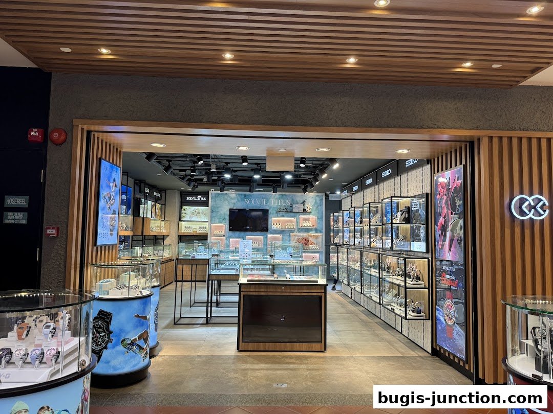 The entrance to a modern watch store, City Chain, showcasing various timepieces in display cases.