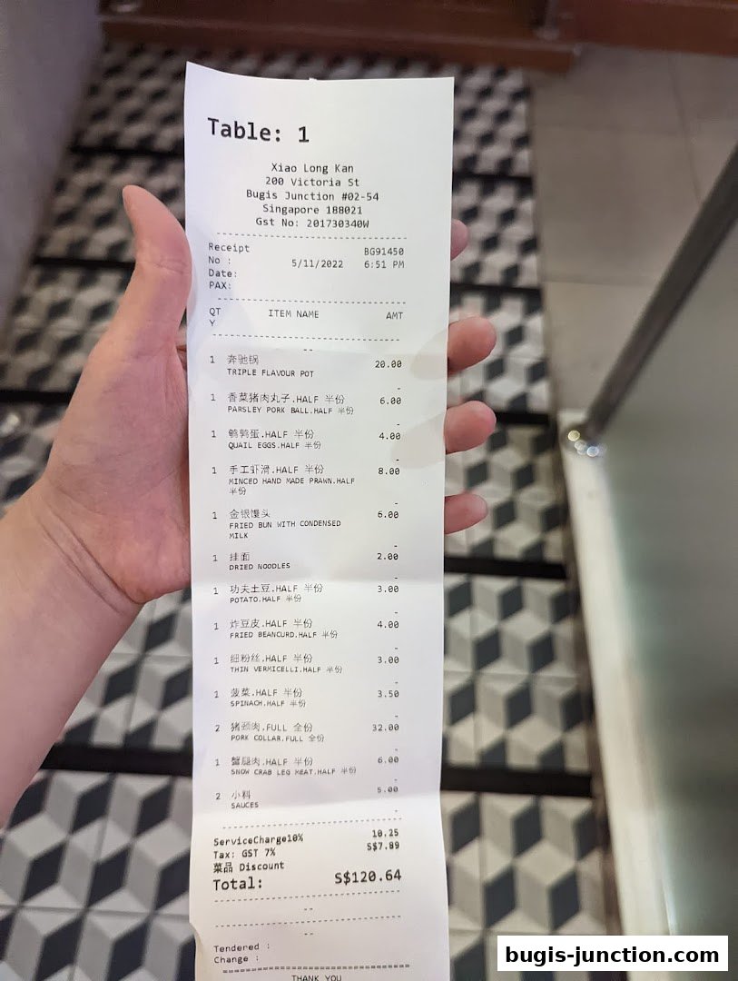 A receipt from Xiao Long Kan Hotpot showing a list of food items and their prices.