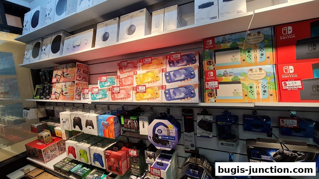 Shelves stocked with various video game consoles, controllers, and accessories.