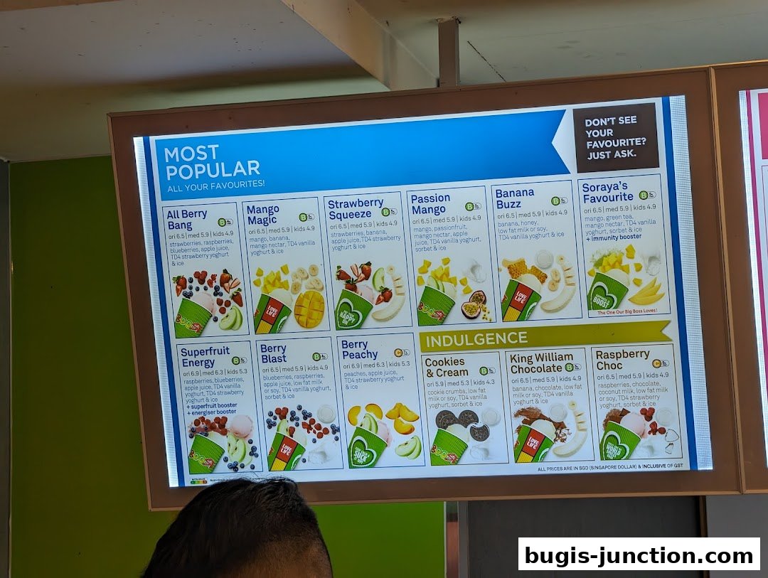 A brightly lit menu board displaying popular and indulgent smoothies with their ingredients and prices.